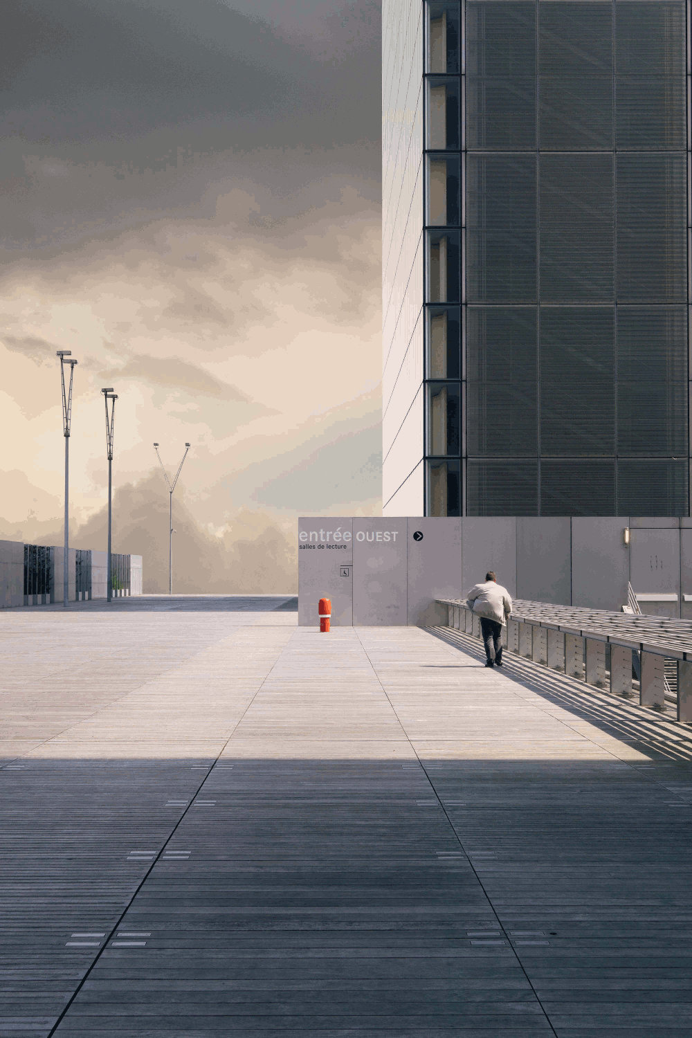 solitary person in broad concrete space by Pierre Chatel-Innocenti